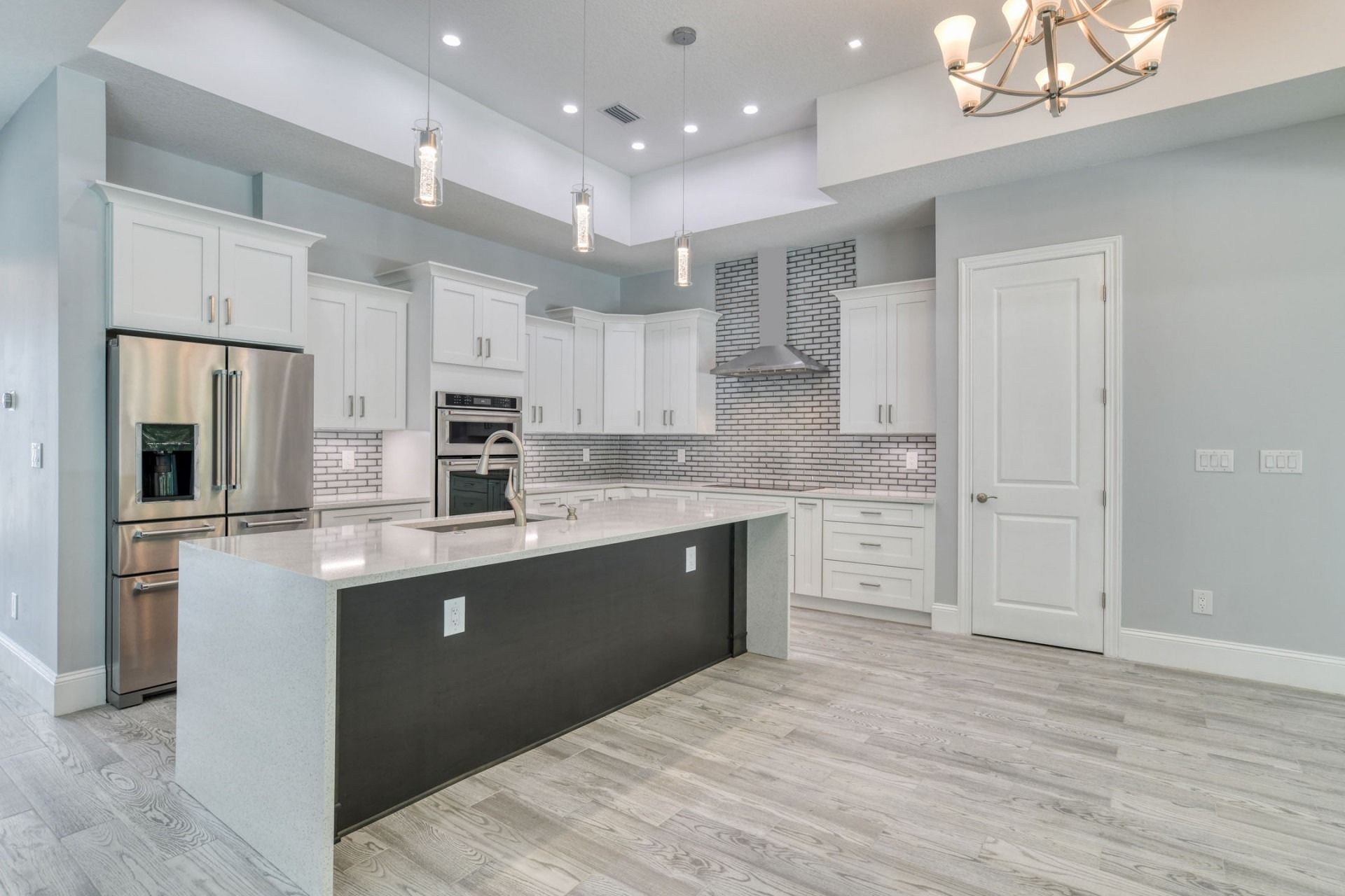 Coastal Elegance kitchen remodel featuring white shaker cabinetry and a generous island